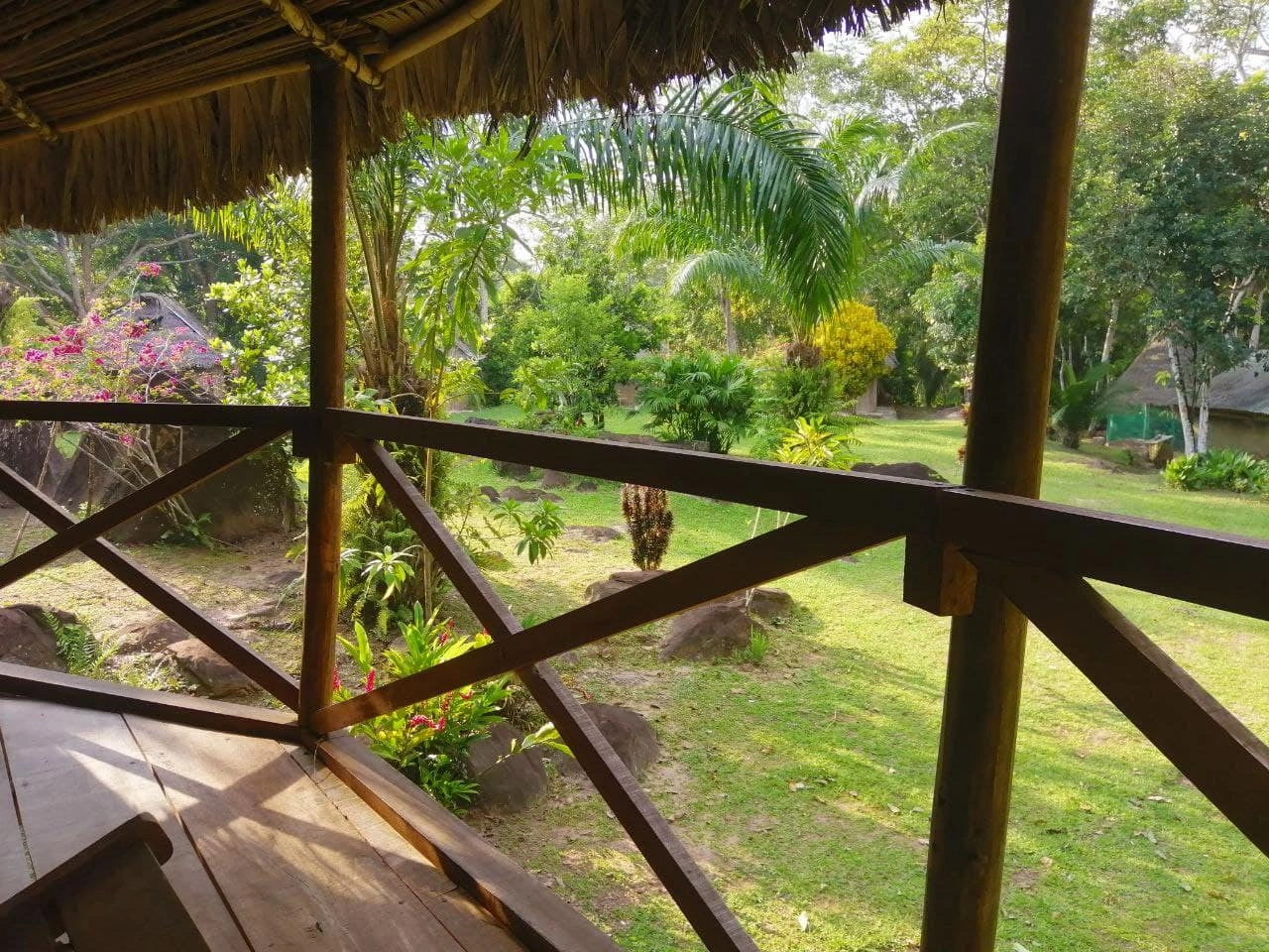 View from a shaded veranda across the gardens at Nova Terra